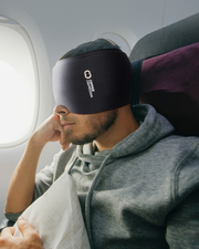 Copper Compression CopperFreeze Migraine Mask, a man on a plane wearing the mask pushed up as a headband