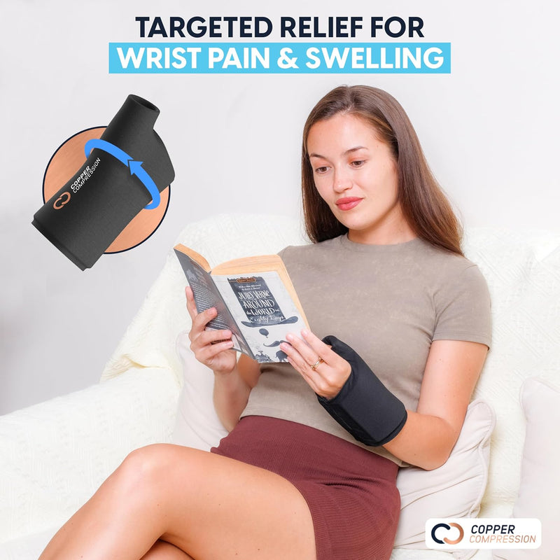 Copper Compression CopperFreeze Wrist Sleeve, a woman reading in bed while wearing the wrist sleeve