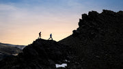 Garmin Enduro 4, two trail runners crossing a ridge at dusk
