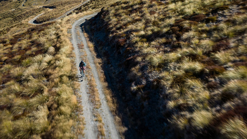 Garmin Enduro 4, cyclist riding a gravel road through the hills