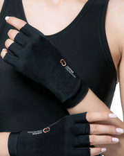 Copper Compression Half Finger Gloves, the gloves worn on a womans hands against a black top