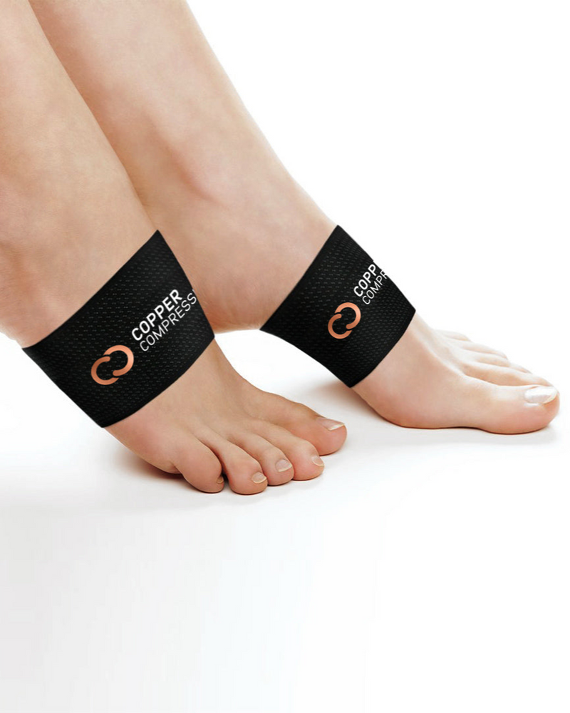 Copper Compression Arch Support Sleeves, the black arch supports worn on both feet, standing