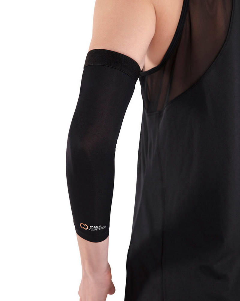 Copper Compression Elbow Sleeve, the elbow sleeve on a straight arm against a dark background