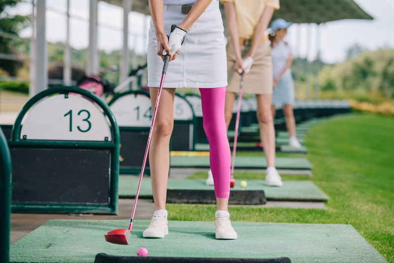 Copper Compression Full Leg Sleeve, a pink full leg sleeve worn on a leg beside a black one