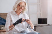 Copper Compression Half Finger Gloves 2 Pack, an older woman knitting while wearing the gloves