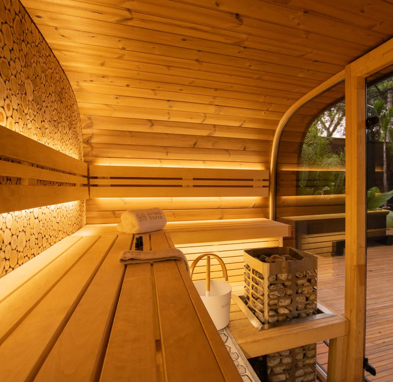 Homecraft Revive sauna heater in a lit sauna with long benches
