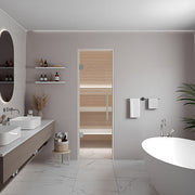 SaunaLife HOME Series kit, 5 x 6 ft sauna in a bathroom, behind its glass door