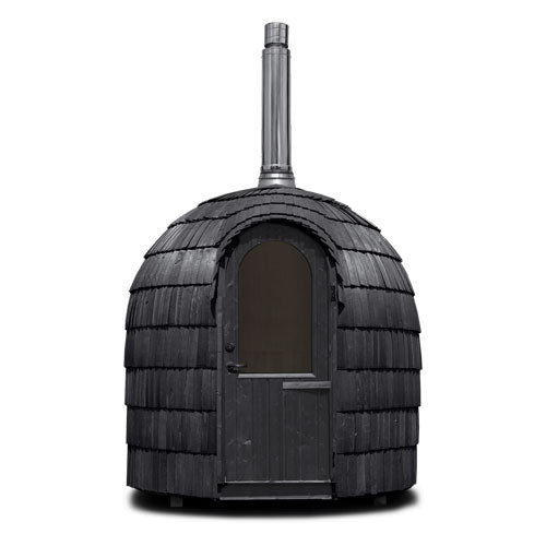 Studio render of the Ebony Single Iglusauna showing the dome form clearly — arched wooden door, triple-layered spruce shingles in deep black, stainless steel chimney rising from the roof