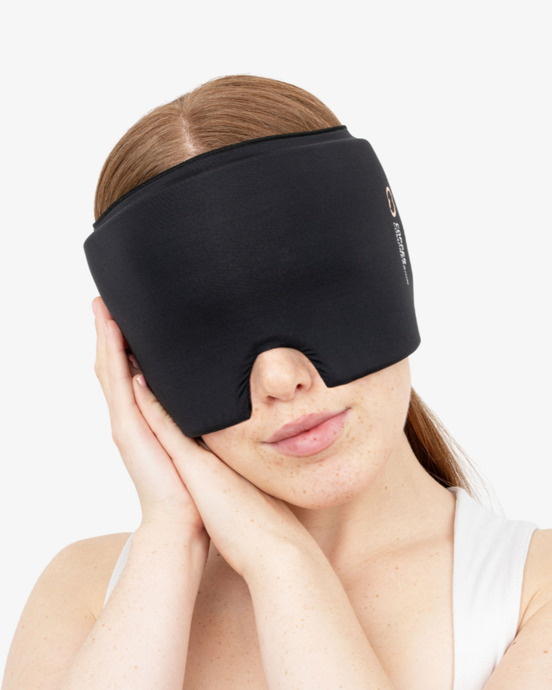 Copper Compression CopperFreeze Migraine Mask, a woman wearing the black mask over her eyes and forehead
