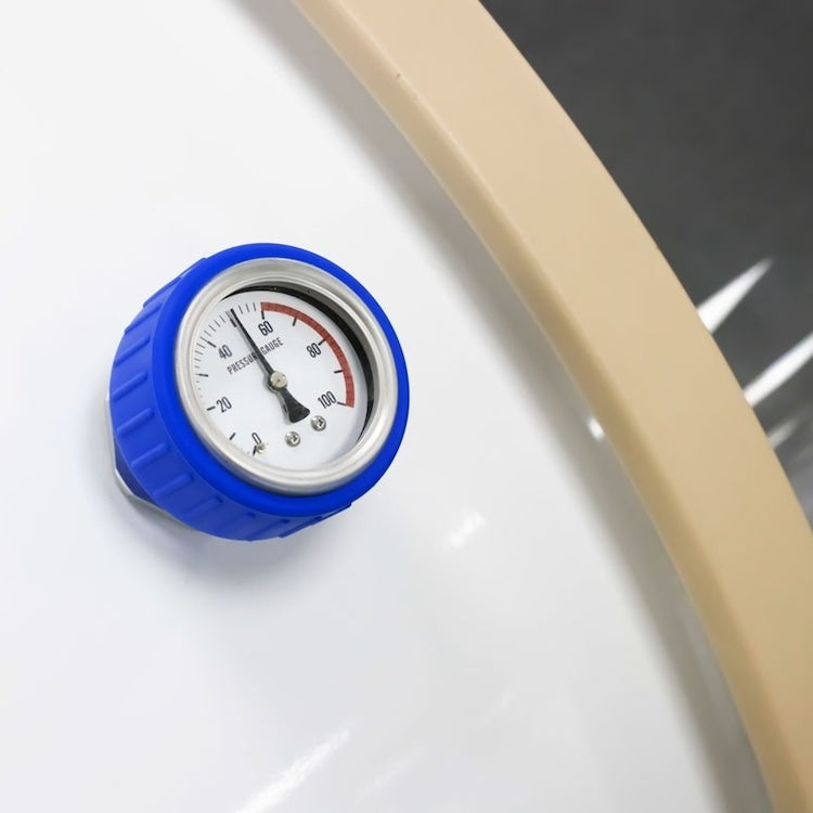 Close-up of a blue analogue pressure gauge mounted on the shell of an OxyRevo hard hyperbaric chamber