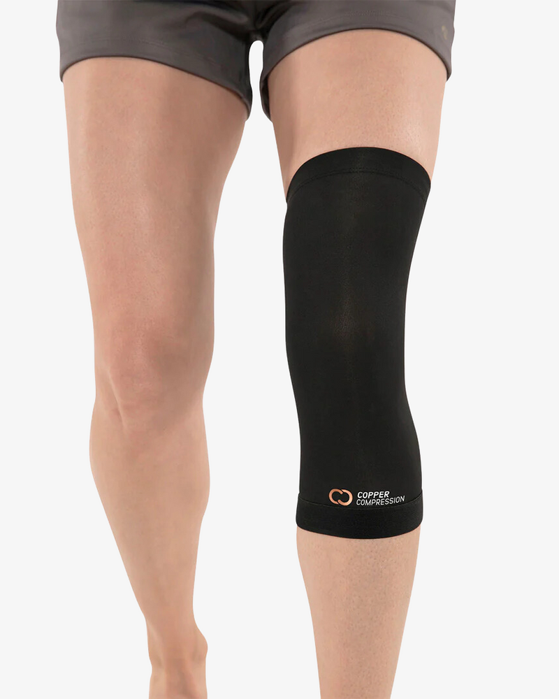 Copper Compression Knee Sleeve, the black knee sleeve worn on a standing leg, seen from the front