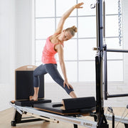 Merrithew Jumpboard fitted to a V2 Max Reformer during a lunge stretch
