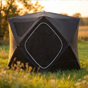 Tent on grass at golden hour, front panel closed