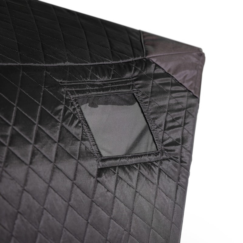 Close-up of the quilted tent fabric with the window panel rolled up and held by its strap