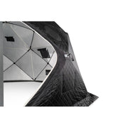 Two people carrying the packed tent bag and the gas heater between them