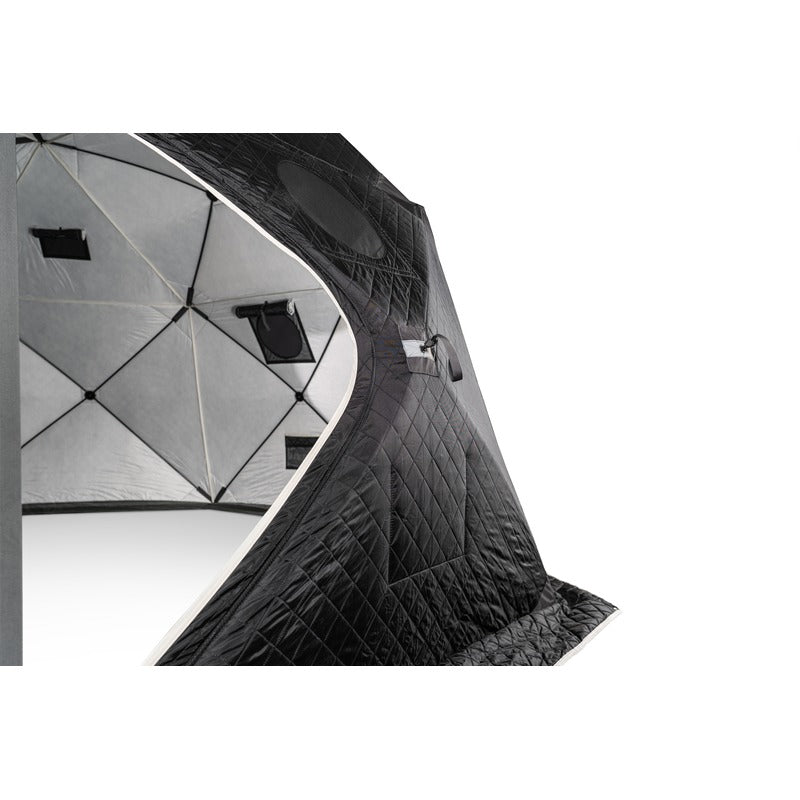 Two people carrying the packed tent bag and the gas heater between them
