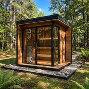 Heater in a cedar-clad outdoor cabin in woodland, full room shot