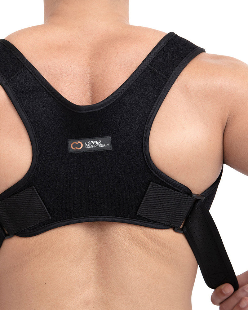 Copper Compression Posture Corrector, the posture corrector on a bare back, straps crossed between the shoulder blades