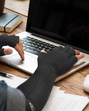 Copper Compression Long Arthritis Gloves, hands in the long gloves at a laptop, holding a pen
