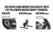 Wahoo KICKR KOM Bundle, KICKR CLIMB under a bike front wheel, dark backdrop