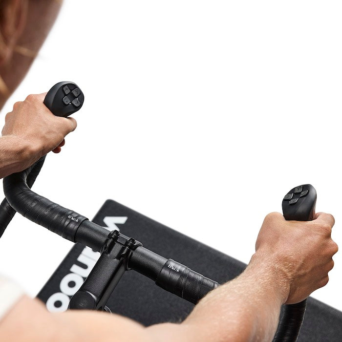 Wahoo KICKR BIKE PRO, hands gripping the handlebar hoods