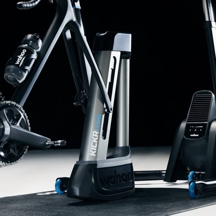 Wahoo KICKR KOM Bundle, KICKR CLIMB with a rider on an orange bike
