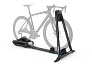 Wahoo KICKR ROLLR, rollers with a grey road bike, flywheel housing at base