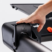Wahoo KICKR RUN, hand on the console arm paddle controller with orange accent