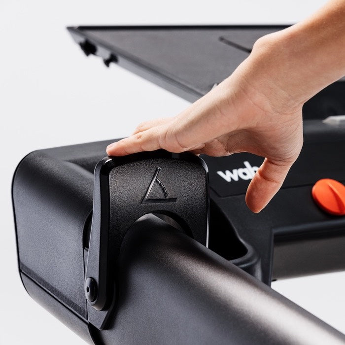 Wahoo KICKR RUN, hand on the console arm paddle controller with orange accent