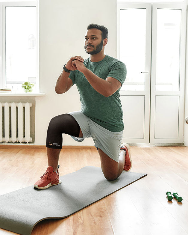 Copper Compression Knee Sleeve, a man in a lunge on an exercise mat wearing the knee sleeve