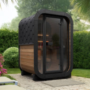 SaunaLife CL3G 2-Person Cube-Series Outdoor Home Sauna - garden patio setting with hedges