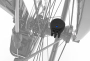 Wahoo TRACKR SPEED Sensor, sensor on a wheel hub among spokes, blue LED