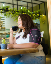 Copper Compression Shoulder Brace, the pink shoulder brace worn on a shoulder