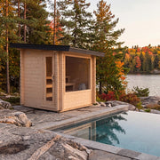 Dundalk Leisurecraft Avalon Sauna beside a pool on a lakeside rock