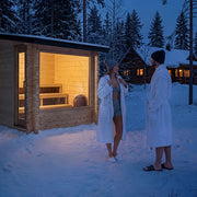 Dundalk Leisurecraft Avalon Sauna lit up at night in the snow