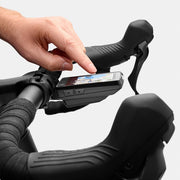 Wahoo ELEMNT ROAM 3, rider's hand tapping the touchscreen, brake hood in frame