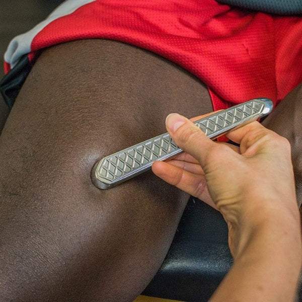 HawkGrips Tongue Depressor HG9 IASTM Instrument being used on leg