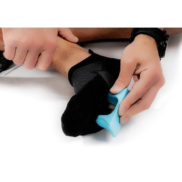 Pro-Mini Muscle Release and Self-Massage Tool being used on bottom of foot
